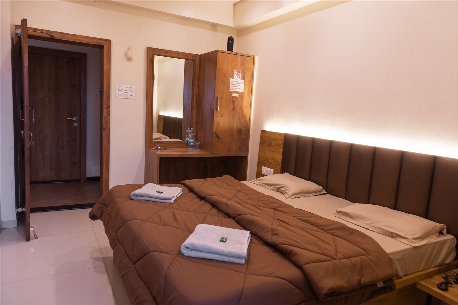 Deluxe room bed with warm cove lighting