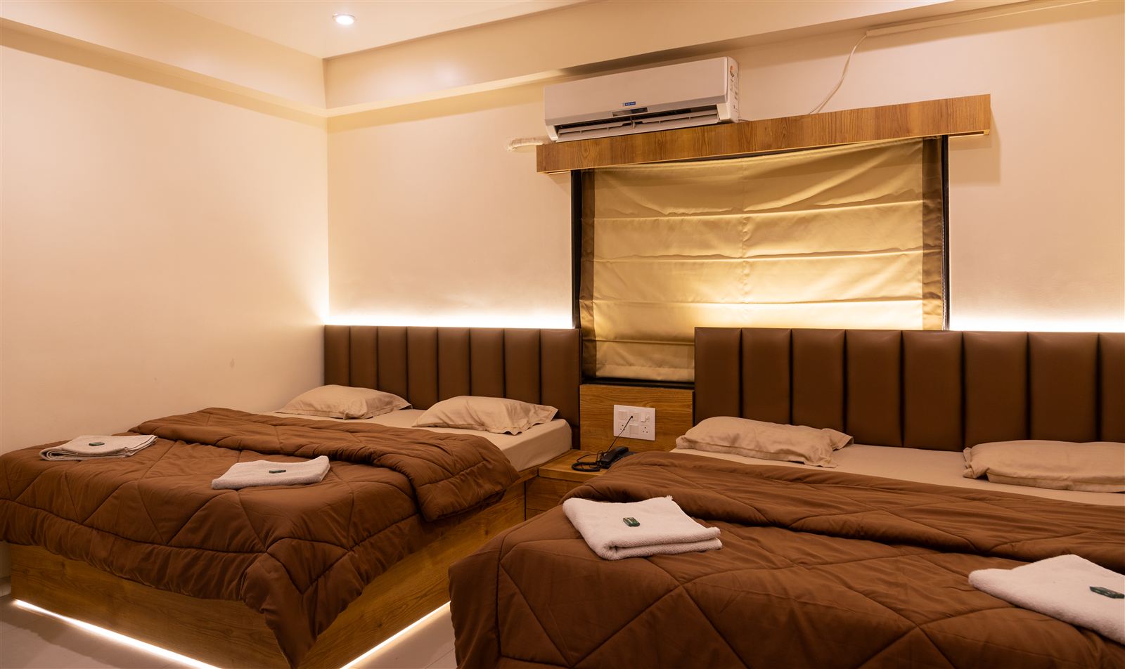 Four bed deluxe room beds with warm lighting
