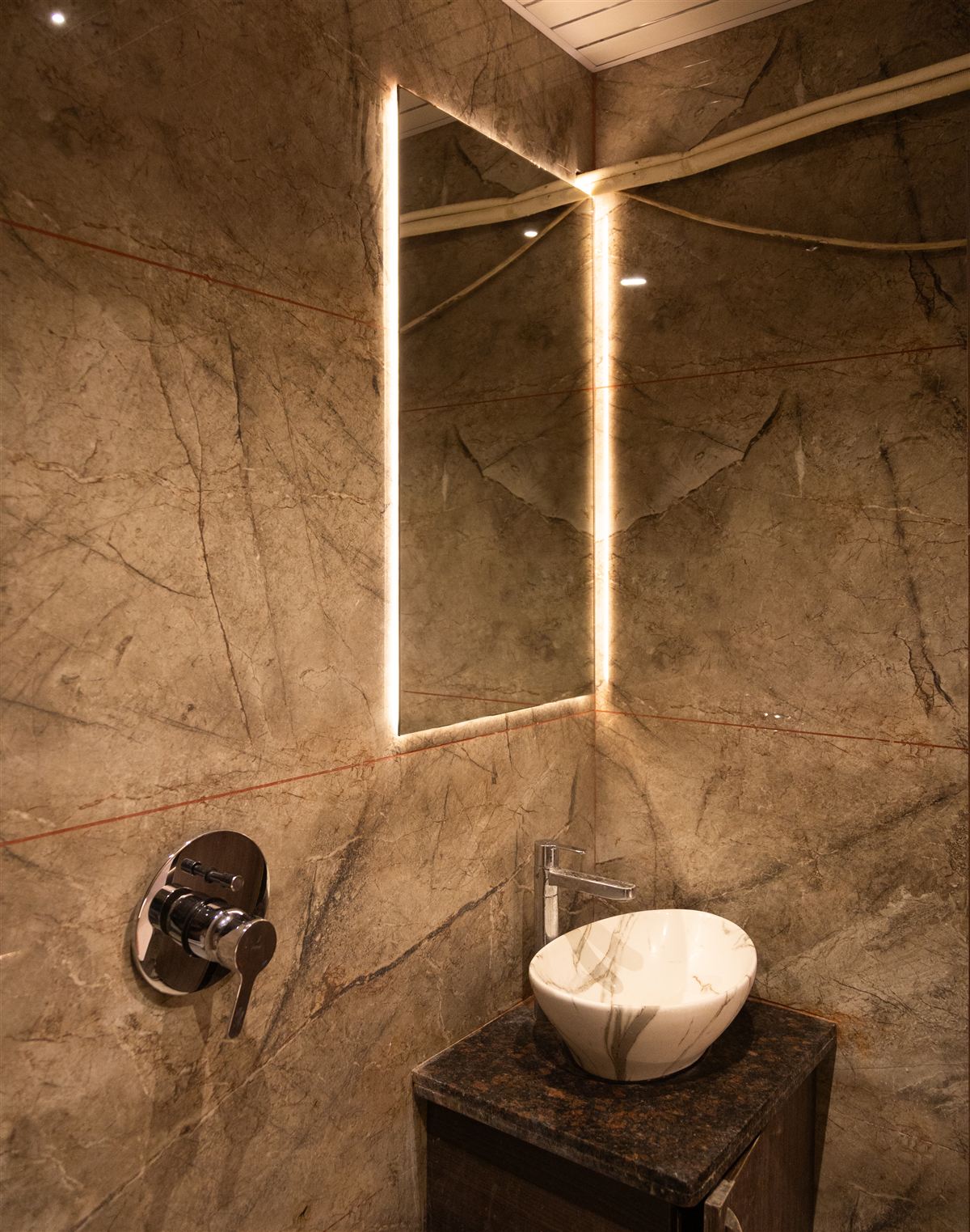 Marble washroom with backlit mirror